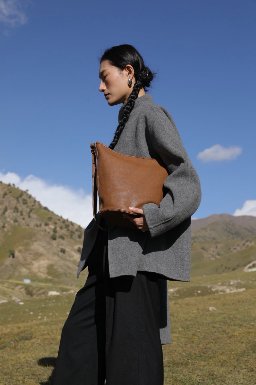 The Bucket Bag in tan full-grain leather, shot on location